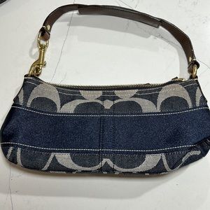 Like New Jean Coach emblem bag. Timeless and chic. Dark leather strap.